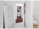 Hallway leading to closet with bright interior, and adjacent half bathroom at 8498 Powder Ridge Trl, Windermere, FL 34786