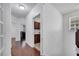 Hallway with dark wood floors leads to rooms with neutral walls and natural light at 8498 Powder Ridge Trl, Windermere, FL 34786