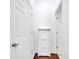 Bright hallway with white doors and a modern storage cabinet at 8498 Powder Ridge Trl, Windermere, FL 34786