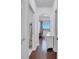 Hallway featuring wood floors, neutral paint, and an arched doorway leading to a bedroom at 8498 Powder Ridge Trl, Windermere, FL 34786