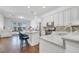 Modern kitchen featuring white cabinets, stainless steel appliances, granite countertops, and a stylish island with seating at 8498 Powder Ridge Trl, Windermere, FL 34786