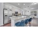 Modern kitchen with stainless steel appliances, white cabinets, a central island, and seating for casual dining at 8498 Powder Ridge Trl, Windermere, FL 34786