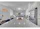 Expansive kitchen island with granite countertops, seating, and seamless flow into the bright playroom at 8498 Powder Ridge Trl, Windermere, FL 34786
