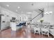 Open-concept kitchen with white cabinetry, stainless steel appliances, and a breakfast bar with stylish blue seating at 8498 Powder Ridge Trl, Windermere, FL 34786