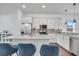 Modern kitchen featuring white cabinets, stainless steel appliances, granite countertops, and a stylish island with seating at 8498 Powder Ridge Trl, Windermere, FL 34786
