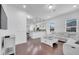 Bright, open-concept living room with a large gray sectional and view into a modern kitchen at 8498 Powder Ridge Trl, Windermere, FL 34786