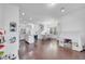 Open living space with hardwood floors, a dining area, a kitchen island with seating and a cute tent at 8498 Powder Ridge Trl, Windermere, FL 34786