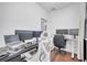 This home office includes multiple monitors and contemporary office furniture at 8498 Powder Ridge Trl, Windermere, FL 34786
