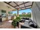 Elegant patio with brick pavers, ample seating, a grill, an outdoor kitchen, and a retractable shade for comfortable outdoor living at 8498 Powder Ridge Trl, Windermere, FL 34786