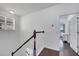 Bright staircase with white walls, dark wood railing and hardwood floors at 8498 Powder Ridge Trl, Windermere, FL 34786