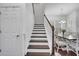 Staircase with wood treads and white risers adjacent to the dining area at 8498 Powder Ridge Trl, Windermere, FL 34786