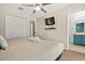 Comfortable bedroom with a king-size bed, ceiling fan, and a view to the bathroom at 8534 Crystal Cove Loop, Kissimmee, FL 34747