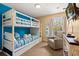 Bright bedroom featuring a bunk bed with striped bedding and a comfortable armchair near the window at 8534 Crystal Cove Loop, Kissimmee, FL 34747