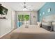 Stylishly furnished bedroom with balcony access, ceiling fan, and peaceful decor at 8534 Crystal Cove Loop, Kissimmee, FL 34747