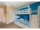 Charming bunk bedroom perfect for , featuring a bright blue accent wall and ample storage at 8534 Crystal Cove Loop, Kissimmee, FL 34747