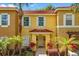 Charming townhouse with a stucco facade, red tile roof, and well-manicured landscaping at 8534 Crystal Cove Loop, Kissimmee, FL 34747