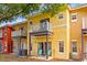 Exterior of a colorful two-story townhouse featuring a private balcony at 8534 Crystal Cove Loop, Kissimmee, FL 34747