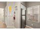Bright kitchen with stainless steel refrigerator, white cabinets, and a window at 8534 Crystal Cove Loop, Kissimmee, FL 34747