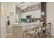 Eat-in kitchen featuring white cabinets, modern appliances, and stylish bar stool seating at 8534 Crystal Cove Loop, Kissimmee, FL 34747