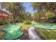 Outdoor mini golf course surrounded by trees and walking paths within a residential community at 8534 Crystal Cove Loop, Kissimmee, FL 34747