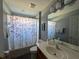 Well-lit bathroom featuring a large mirror, vanity with sink, toilet, and a shower/tub combination at 8631 La Isla Dr, Kissimmee, FL 34747