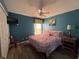 Charming bedroom with hardwood floors, a window, and a full sized bed at 8631 La Isla Dr, Kissimmee, FL 34747