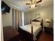 Cozy bedroom featuring a full-sized bed, wood floors, and soft, neutral colors at 8631 La Isla Dr, Kissimmee, FL 34747