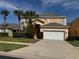 Inviting two-story home featuring a well-manicured lawn and a two-car garage at 8631 La Isla Dr, Kissimmee, FL 34747