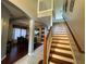 Inviting interior view of a home featuring wood stairs, dining, and kitchen areas at 8631 La Isla Dr, Kissimmee, FL 34747