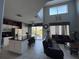 Bright open-concept living area connecting the kitchen, with sleek black leather sofas at 8631 La Isla Dr, Kissimmee, FL 34747