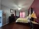 Well-lit bedroom with red accent wall, king-sized bed, and plenty of storage and wardrobe space at 8631 La Isla Dr, Kissimmee, FL 34747