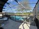 Screened-in pool area featuring pool, hot tub, patio furniture, and safety fence at 8631 La Isla Dr, Kissimmee, FL 34747