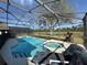 Inviting screened-in pool and jacuzzi offer relaxation with clear views of the expansive backyard at 8631 La Isla Dr, Kissimmee, FL 34747