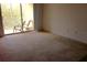 Spacious room with sliding glass doors leading to a sunny balcony with chairs at 8817 Dunes Ct # 8-303, Kissimmee, FL 34747