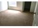 Bright bedroom featuring neutral carpet, window, and adjacent doorway at 8817 Dunes Ct # 8-303, Kissimmee, FL 34747