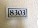 Close up of house number sign reading 8303 attached to a wall at 8817 Dunes Ct # 8-303, Kissimmee, FL 34747