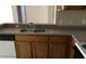 Double sink with faucet and oak cabinetry in the kitchen at 8817 Dunes Ct # 8-303, Kissimmee, FL 34747