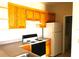 Bright kitchen with wood cabinets, appliances, and laminate countertops at 8817 Dunes Ct # 8-303, Kissimmee, FL 34747