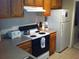 The kitchen shows wood cabinets and updated appliances at 8817 Dunes Ct # 8-303, Kissimmee, FL 34747