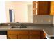 Features a double sink, wood cabinets, and light countertops at 8817 Dunes Ct # 8-303, Kissimmee, FL 34747