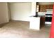 Open living space featuring a kitchen and light-colored carpeting at 8817 Dunes Ct # 8-303, Kissimmee, FL 34747