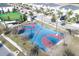 Aerial view of a well-maintained basketball court surrounded by landscaping and neighborhood homes at 8999 Croquet Ct, Davenport, FL 33896