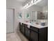 Elegant bathroom with dual vanity, spacious mirror, and modern shower at 8999 Croquet Ct, Davenport, FL 33896