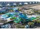 Expansive view of community amenities, showcasing a waterpark, pool, and surrounding residential buildings at 8999 Croquet Ct, Davenport, FL 33896