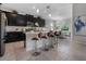 Beautiful kitchen with stainless steel appliances, bar seating, and adjacent dining area at 8999 Croquet Ct, Davenport, FL 33896