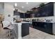 Well-lit kitchen featuring dark cabinets, a white countertop island, and barstool seating at 8999 Croquet Ct, Davenport, FL 33896