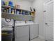 Efficient laundry room with modern washer, dryer, and ample shelving at 8999 Croquet Ct, Davenport, FL 33896