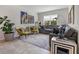 Inviting living room with stylish furniture, a neutral color palette, and eye-catching artwork at 8999 Croquet Ct, Davenport, FL 33896