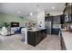 Open-concept living space with kitchen island, comfortable seating, and stylish accents at 8999 Croquet Ct, Davenport, FL 33896