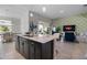 Bright open floor plan featuring kitchen, dining area, and inviting living room at 8999 Croquet Ct, Davenport, FL 33896